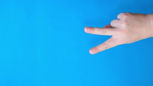 Hand With Two Fingers on Blue