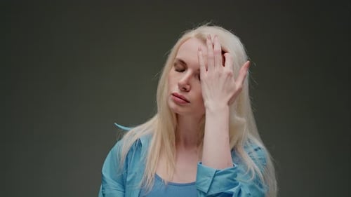 Beautiful Blonde Middleaged Girl with Long Hair in the Studio Beauty Portrait of a Face with Big