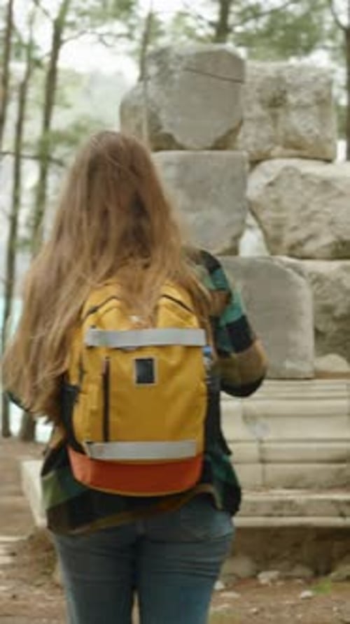 Woman Walking To Ancient Ruins in Forest