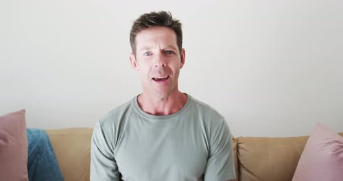 Man Talking Directly to Camera Indoors on Couch