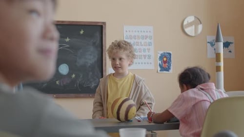 Young Children Learning About the Planets in Classroom
