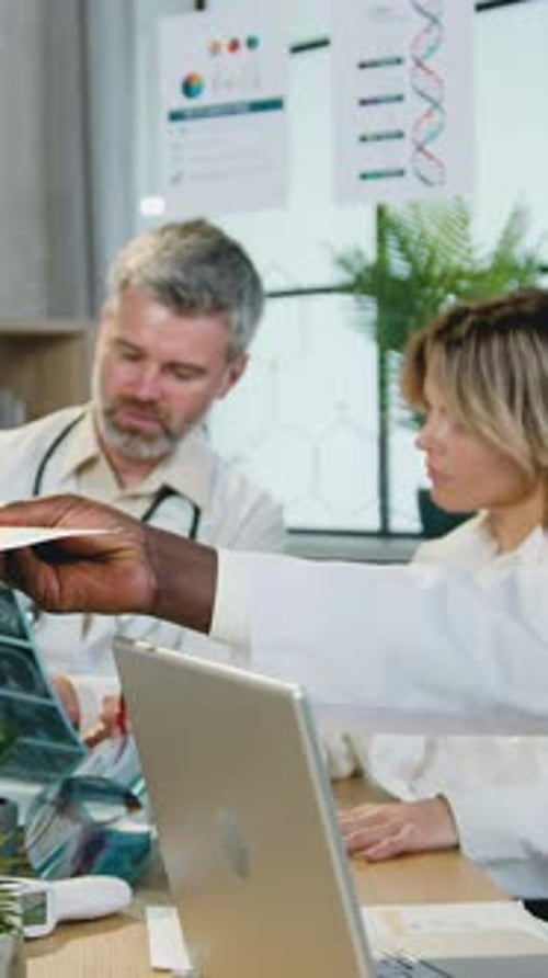 Medical Professionals Discussing X-ray in Office