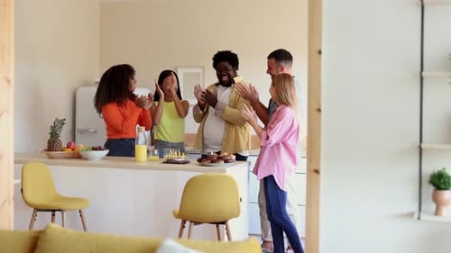Friends Celebrating a Birthday Together in Kitchen