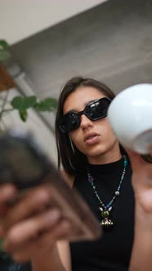Stylish Woman with Phone and White Ball
