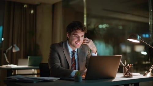 Smiling Man Working Late in Office