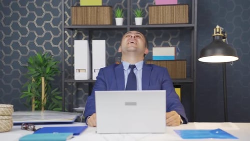 Cheerful businessman laughing playfully.