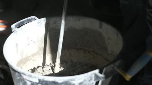 Close Up Cement Mixing in Bucket