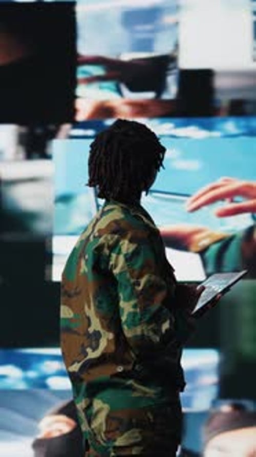 Vertical Video Military Officer in War Room Oversees Mission Operations Using Tablet App