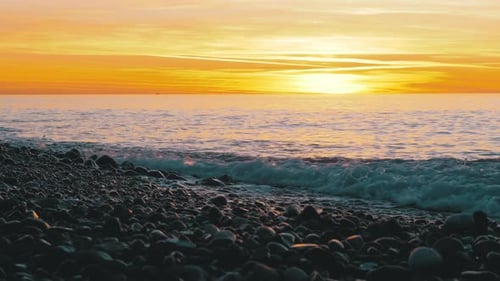 Beautiful Sunset Over the Sea Near the Rocky Shore