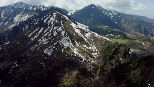 Aerial passing over the icy mountains to the houses of the top of the mountains, Other big mountain