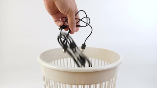 09. Old computer cables are thrown into the trash can. Disposal of household waste.
