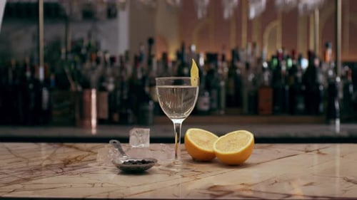 Fancy Cocktail, on an Ornate Marble Topped Bar Decorated with Juniper Berries
