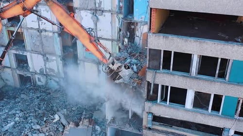 Excavator Demolishing a Building in an Urban Environment