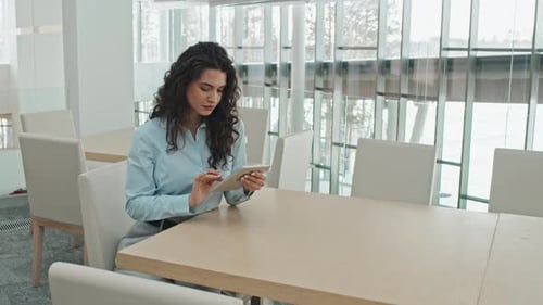 Businesswoman Using Tablet Computer in Office