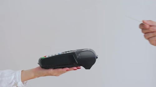 Man Swipes Card Through POS Terminal
