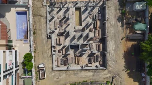 Aerial View Construction Site at Work Equipment and Workers Building Foundations