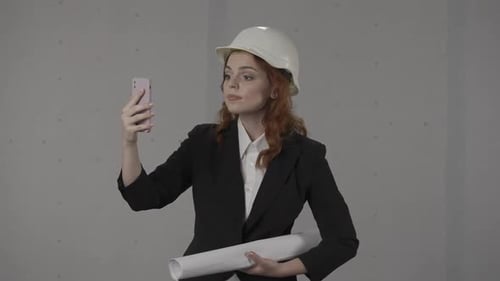 Woman Architect Video Conferencing with Hard Hat