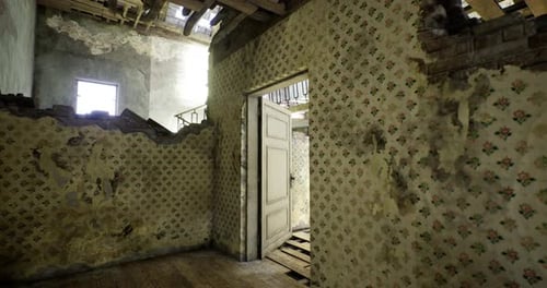 Abandoned Room with Peeling Wallpaper and Exposed Floor in Historic Building