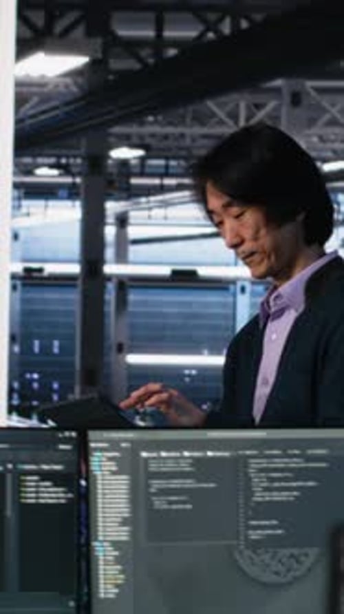 Vertical Video Data Center Manager Supervising Developer Using Device to Monitor Neural Network