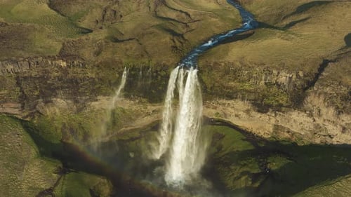 Drone Shot of Famous Icelandic Seljalandsfoss Waterfall and Green Landscape on Sunny Day