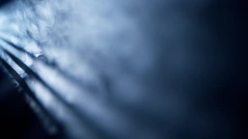 Blue Light Beams Shining Through Dense Fog