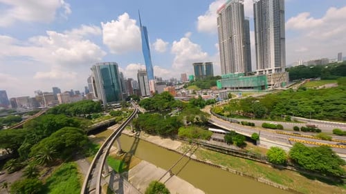 Cinematic FPV Drone Flight Over LRT Train Tracks with Kuala Lumpur City Skyline