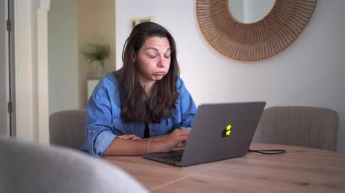 Stressed Woman Working at Her Laptop at Home