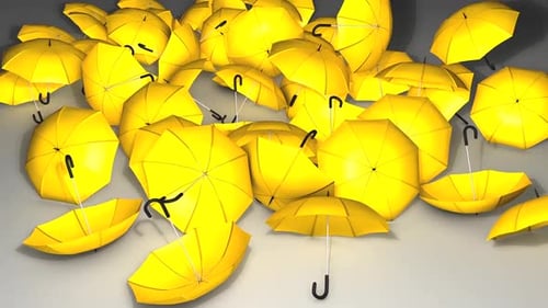 Scattered Yellow Umbrellas on Gray Surface