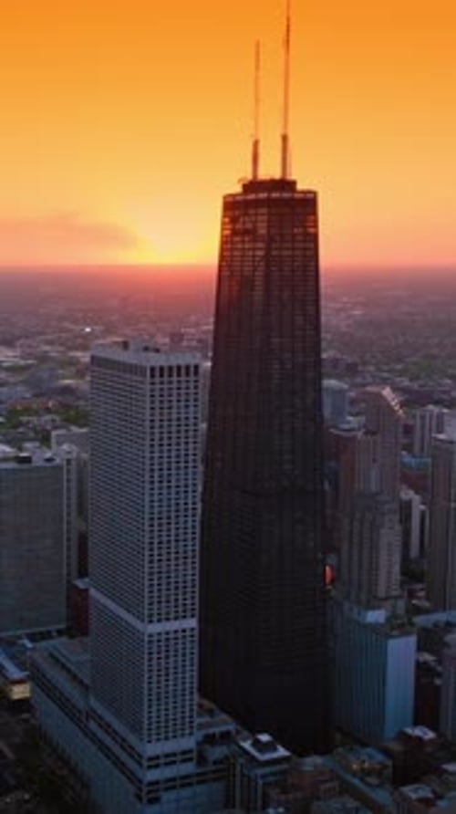 Splendid scenery of vast Chicago at setting sun. Metropolis skyline against orange skies backdrop