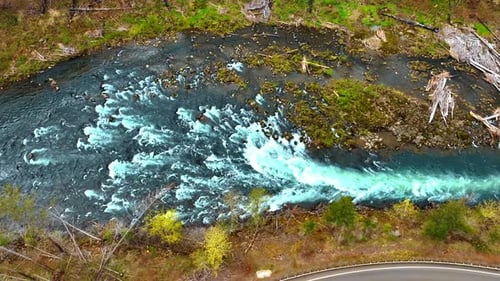 Narrow mountain river with rapids becomes narrower flowing quickly.