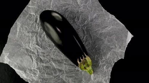 Plump Eggplants Placed on Crinkled Baking Paper Ideal for Cooking Video