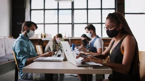 Coworkers Working with Laptops in Masks at Tables
