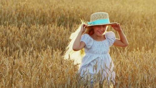 Blonde Girl with Long Hair in a Wheat Field