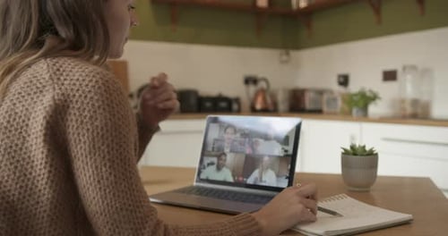 Woman Participating in a Video Conference Call at Home