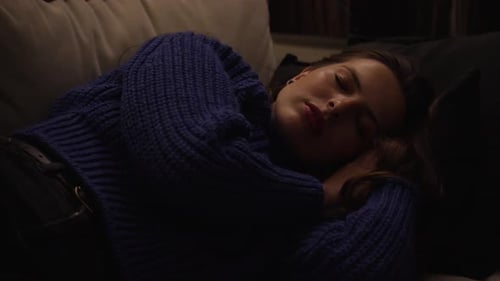Young Adult Woman Relaxing on Couch at Night