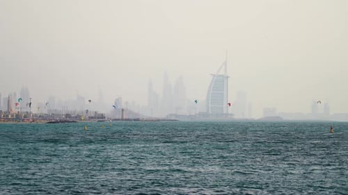 Dozens of kite surfers enjoy Kite beach against the Dubai Skyline