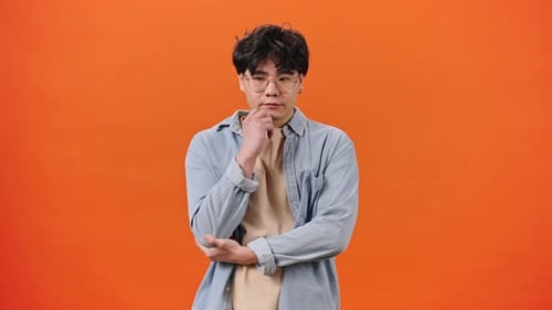 Man Thinking and Getting an Idea on Orange Background