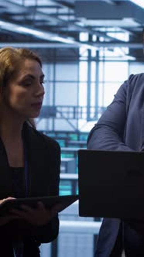 Vertical Video Coworkers in Server Room Optimizing Data Center Hardware Equipment