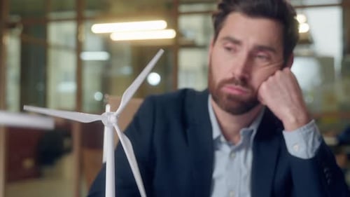 Upset Frustrated Caucasian Business Man Looking Windmill Thinking Typing Laptop at Office