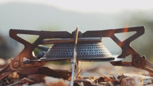 Portable Camping Stove Being Lit and Cooking