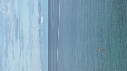 a Girl on a Paddle Board in the Sea on a Sunny Day the Shore of the Blue Sea in Sunny Weather Calm