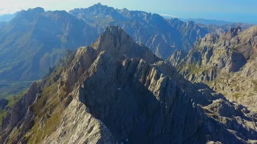 Aerial over Picos de Europa: Peaks as sentinels, nature's fortress on high.