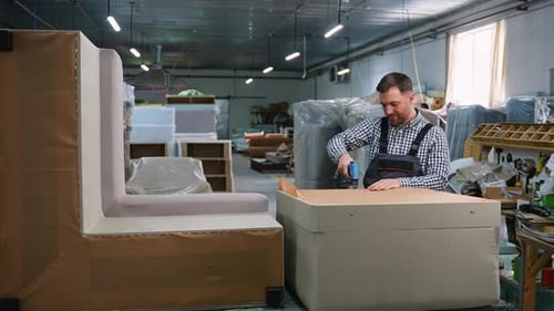 Worker Assembling Sofa Frame in Upholstery Workshop