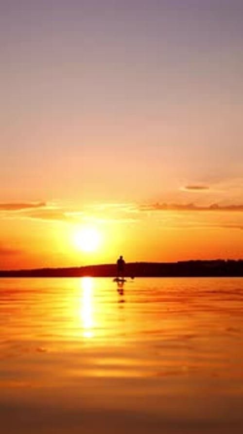 Silhouette Paddle Boarder Enjoying a Beautiful Sunset