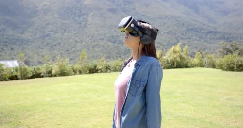 Woman Wearing VR Headset in Green Field
