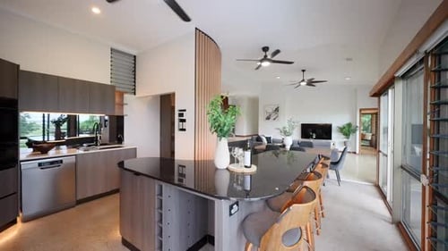 Modern luxurious architecturally designed kitchen with back stone bench tops, black fans, louver win