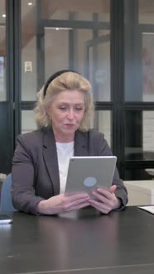 Senior Old Business Woman Doing Video Chat on Tablet in Office, Vertical Video