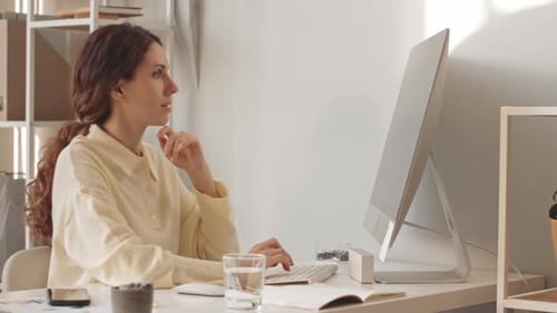 Young Woman Working on Computer in Office