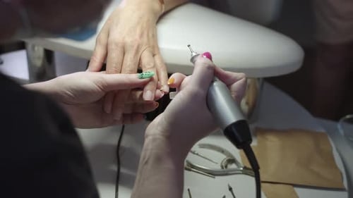 Manicurist Uses Nail Tool on Client in Salon