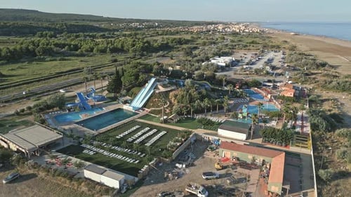 Exploring a vibrant water park along the coast featuring slides, pools, and beautiful landscapes